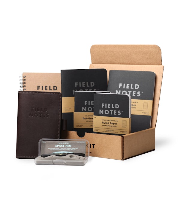 Desk Kit including planner, Pitch Black books, Daily Carry leather notebook cover, and Space Pen.